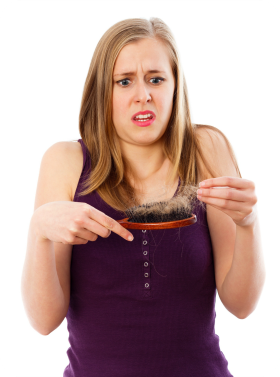 Woman seeing hair loss on brush