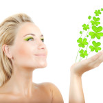 woman holding four leaf clovers